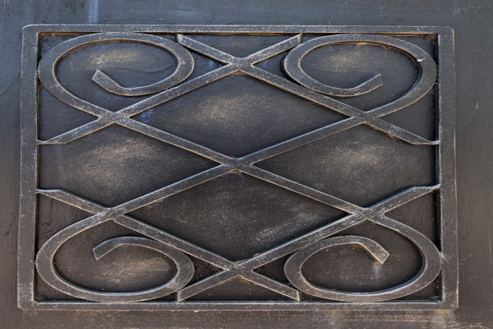 old metal ornament on entrance gate rusty and dirty