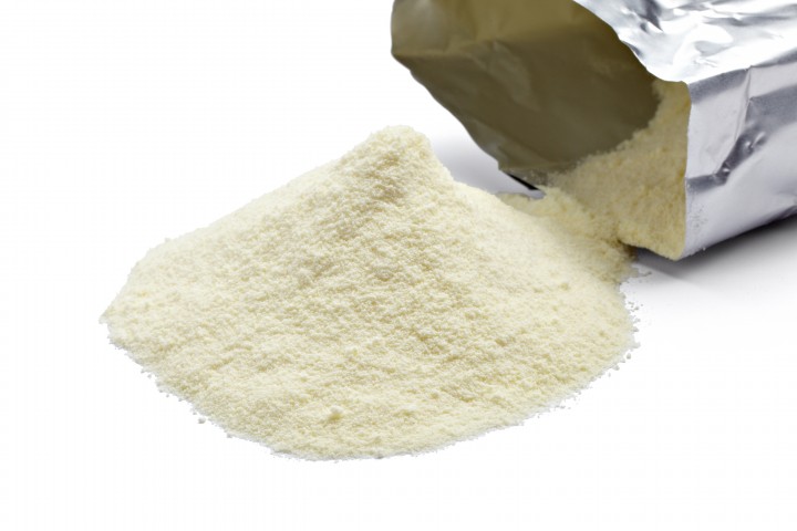 milk powder close up of powdered milk and spoon for baby on white background with clipping path