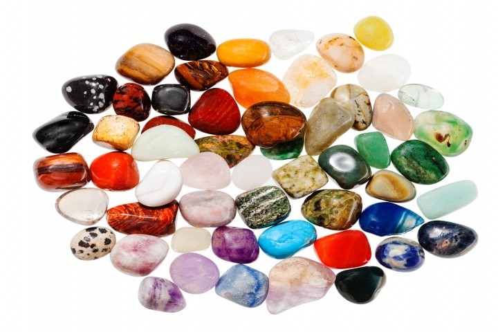 top view of many polished natural mineral gemstones isolated on white background