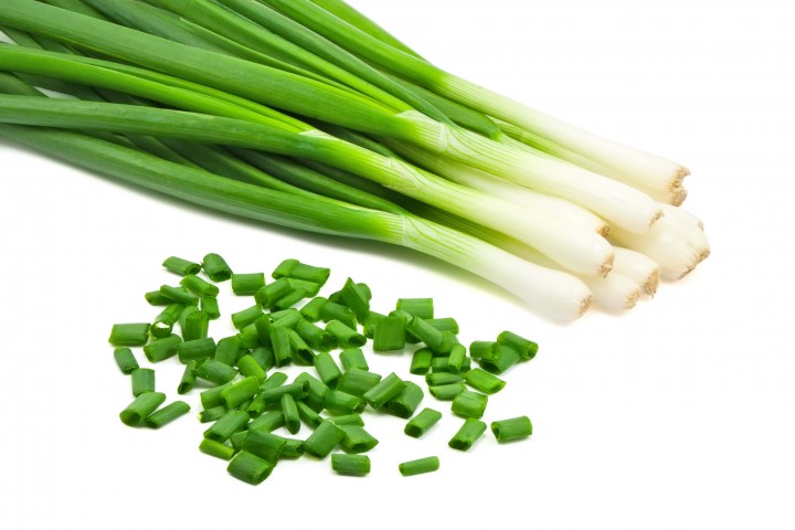 chopped green onions on white