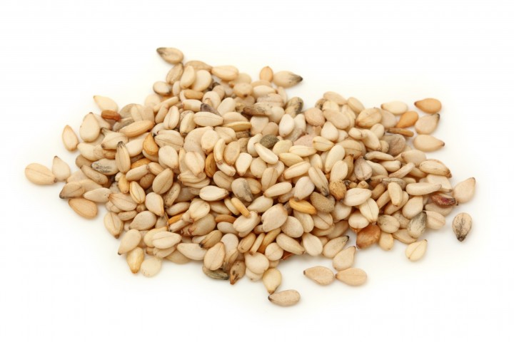 til sesame seeds isolated on white background macro shot
